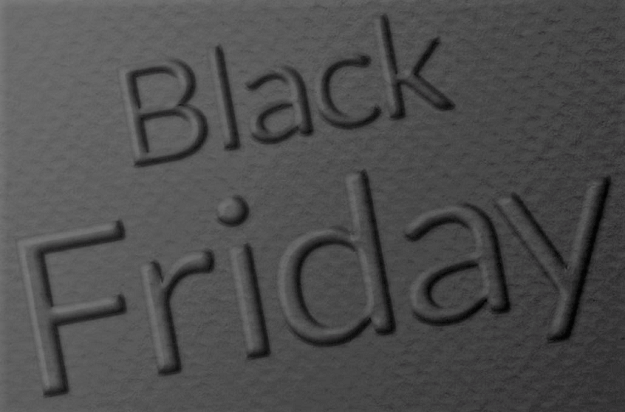 The words Black Friday embossed on a dark substrate