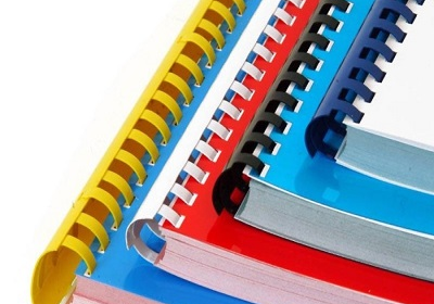 A stack of different colored Comb Bound books