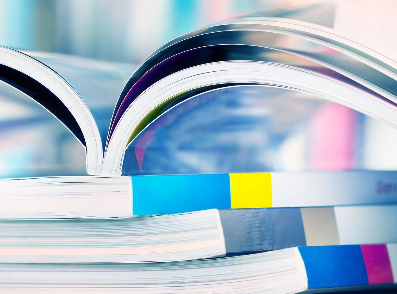 A stack of colorful perfect bound books