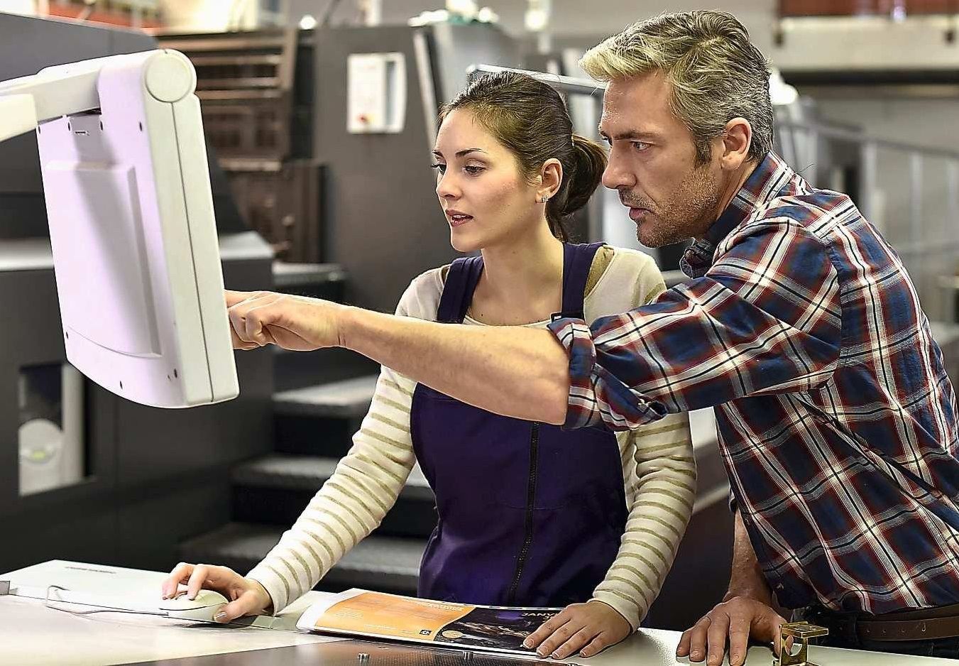 A female worker and a male worker in a printing plant