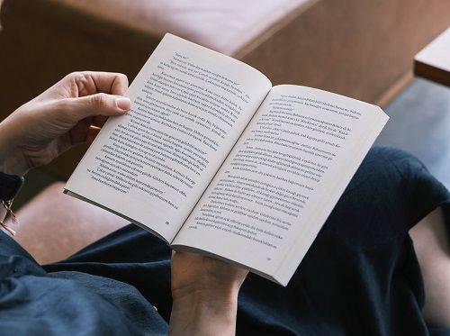 A person holding an open book