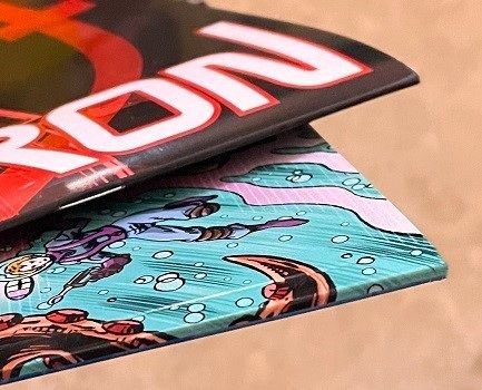 The spine of a saddle stitched comic book compared to the spine of a perfect bound comic book