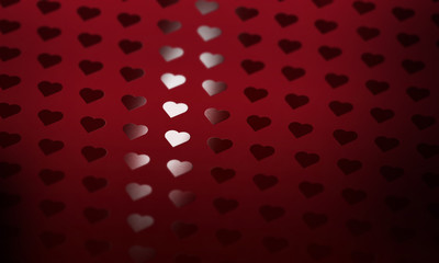 Spot Gloss UV applied as a pattern of hearts on red paper