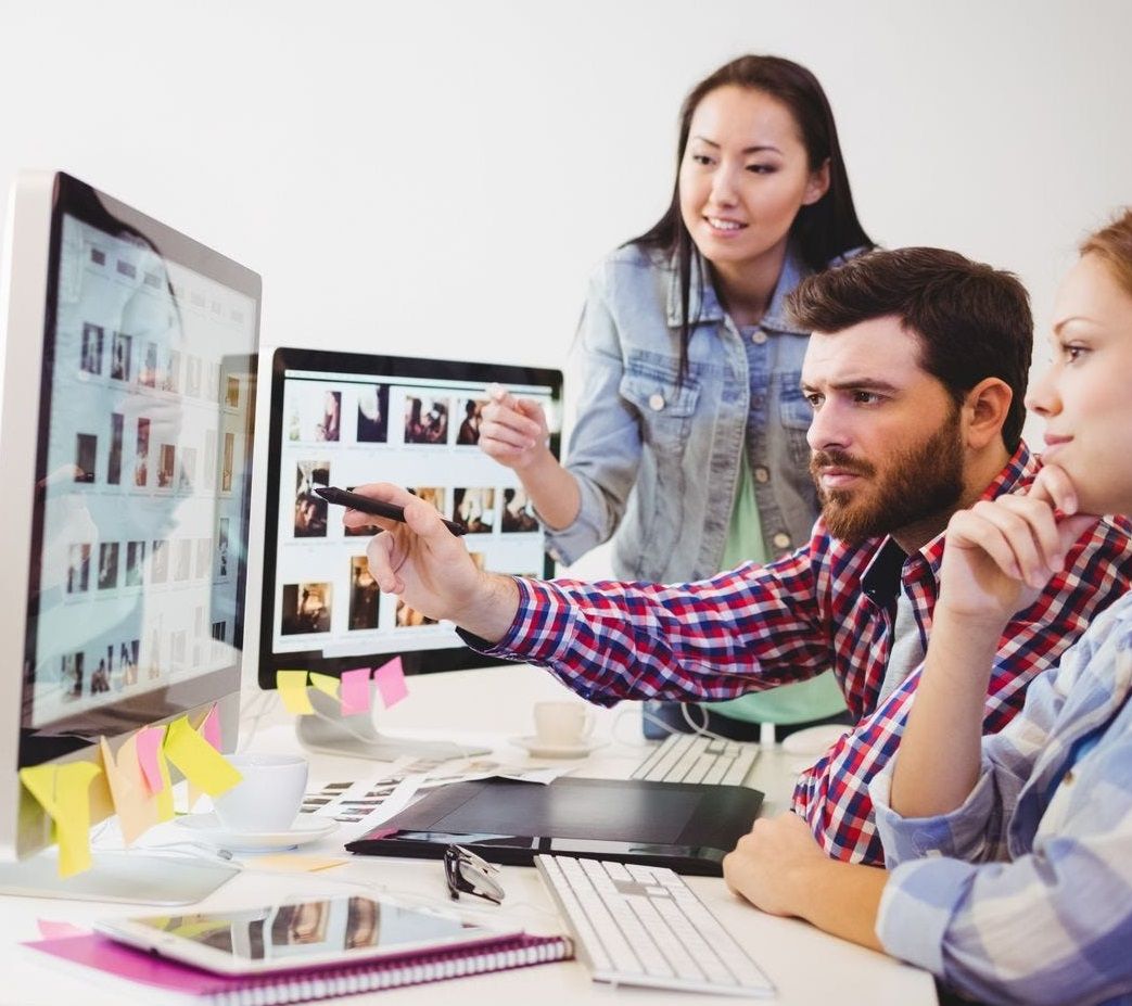 A graphics team discussing a print project