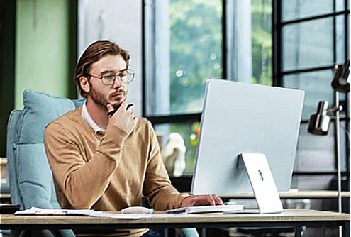 A male graphic designer working at his computer