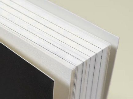 A thick softcover book with a heavy cardstock cover