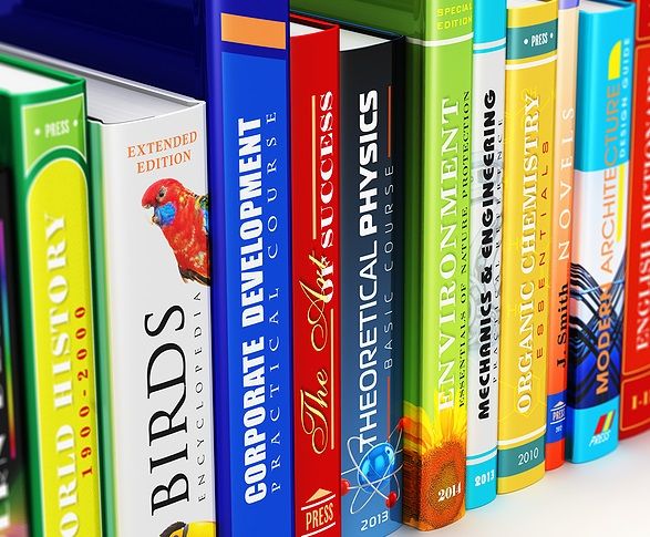 A row of books on a shelf exhibiting colorfully printed spines