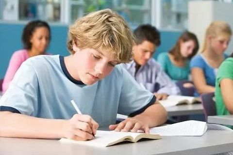 Printed workbooks being used in the classroom