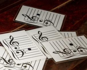 Laminated music flash cards lying on a piano 