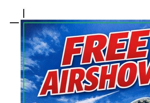 A flyer for an Airshow showing crop marks at one corner and a green line indicating where to trim off the bleed.en