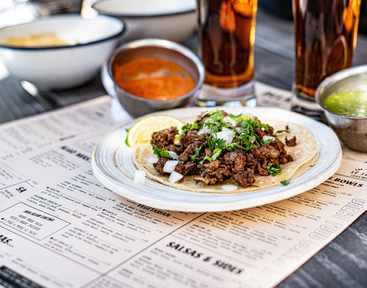 A plate of food sitting on several Printed Menus