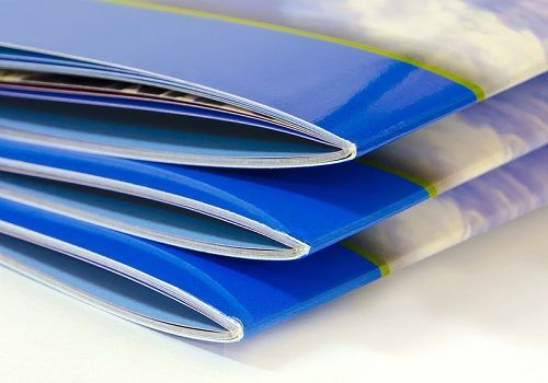 A stack of three saddle stitched booklets