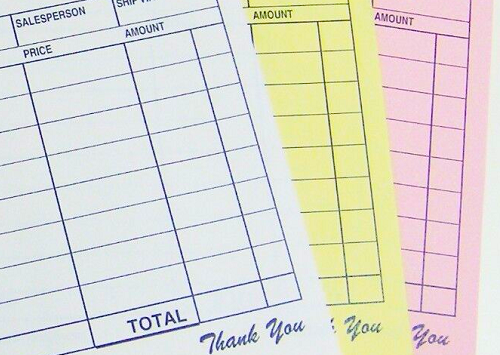 The white, yellow, and pink plies of a 3-part carbonless business form