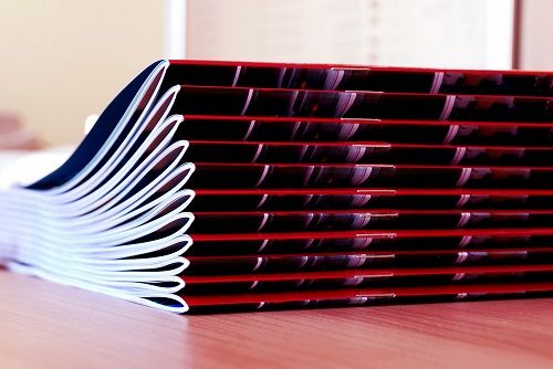 Saddle stitched books stacked on a table