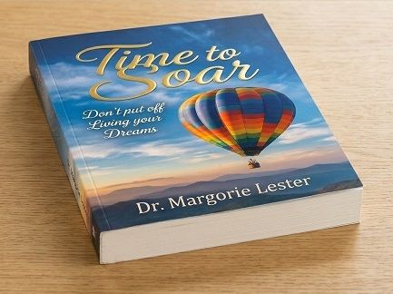 A motivational book entitled Time to Soar lying on a wooden tabletop