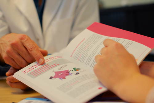 Two people looking at a printed booklet