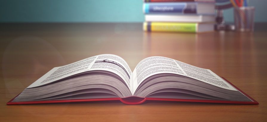 A hardcover book lying open on a table