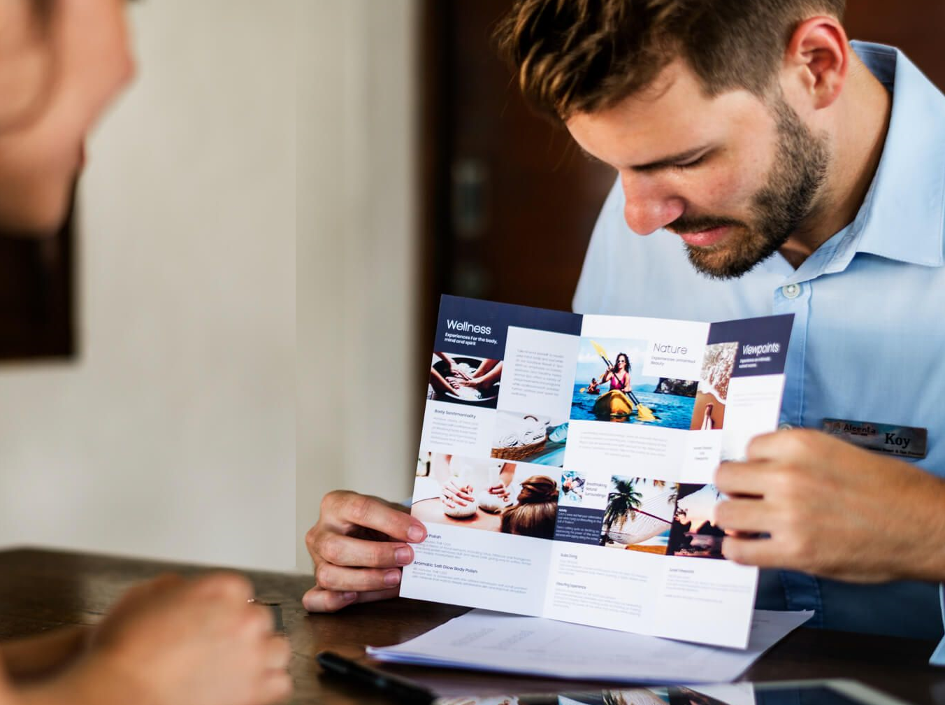 A salesman showing a brochure to a client