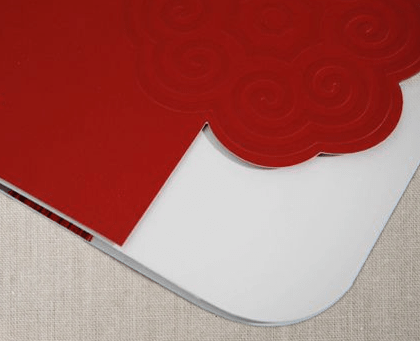 A pattern die-cut into a red cardstock brochure cover