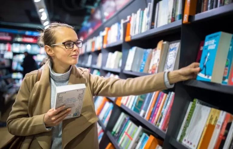 A woman looking at books in a bookstore