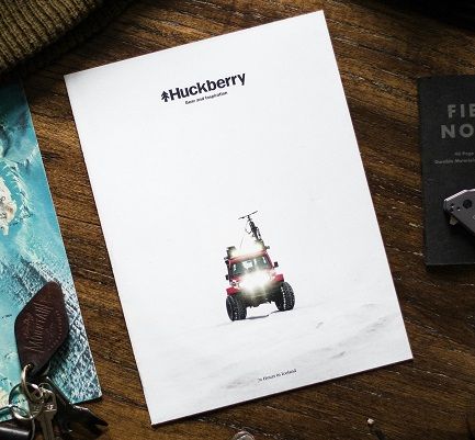 A white catalog for outdoor gear lying on a wooden table