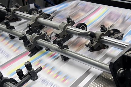 Paper flowing through an offset printing press
