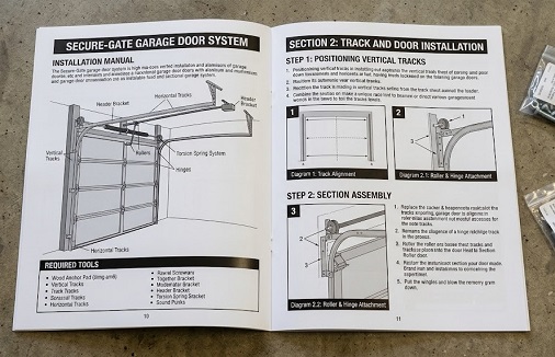 A saddle stitched installation manual printed in black ink on white paper and lying open on a work surface