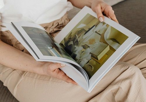 A woman looking through a high-end art book