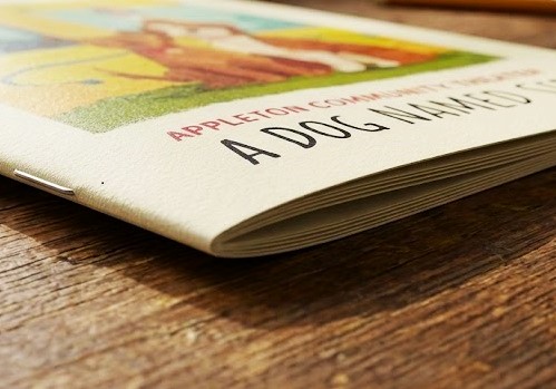 A close up view of a saddle-stitched community theater program for a play entitled "A Dog Named Sid"