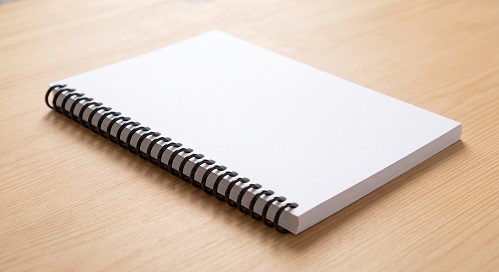 A spiral coil bound book dummy with blank pages and cover.