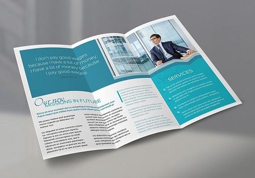 A tri-fold brochure for a financial services company lying open on a surface