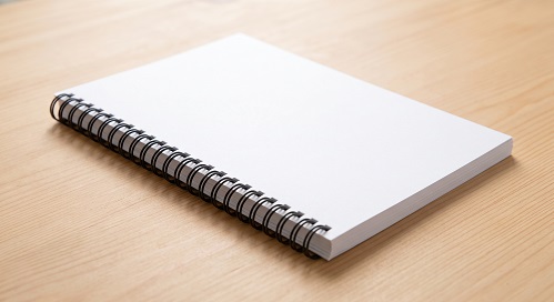 A wire-o bound book dummy with blank pages and cover.