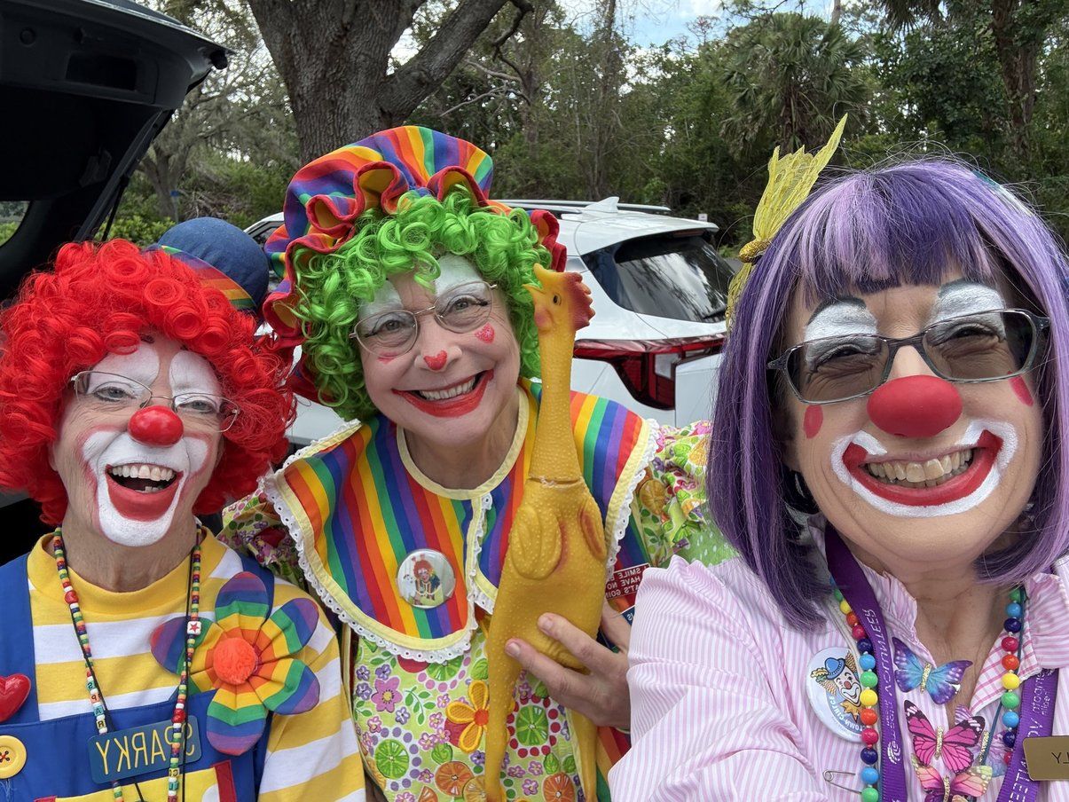 three hospice clowns smile for the camera