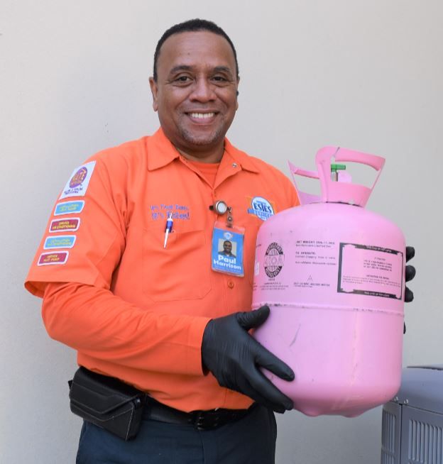 Paul, Estes Heating and Air Repairman holding a  410A Refrigerant