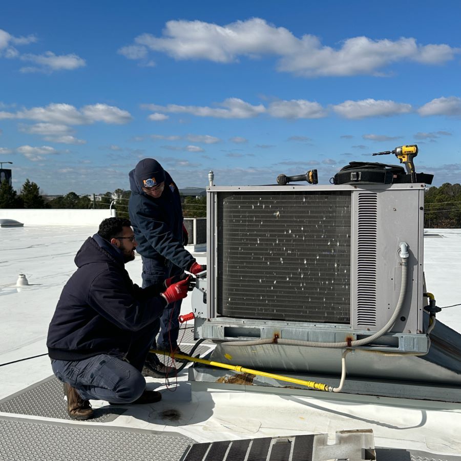 Estes Commercial HVAC Techs repairing an HVAC