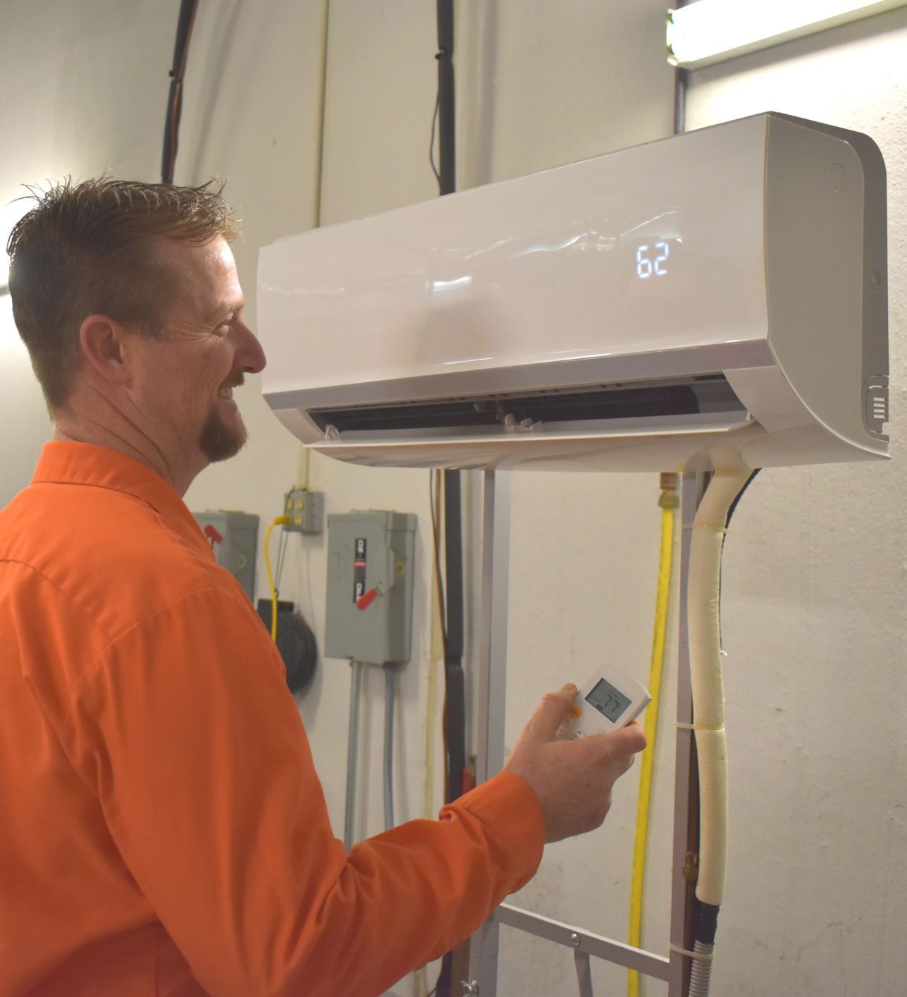 Estes Technician operating a Ductless mini split