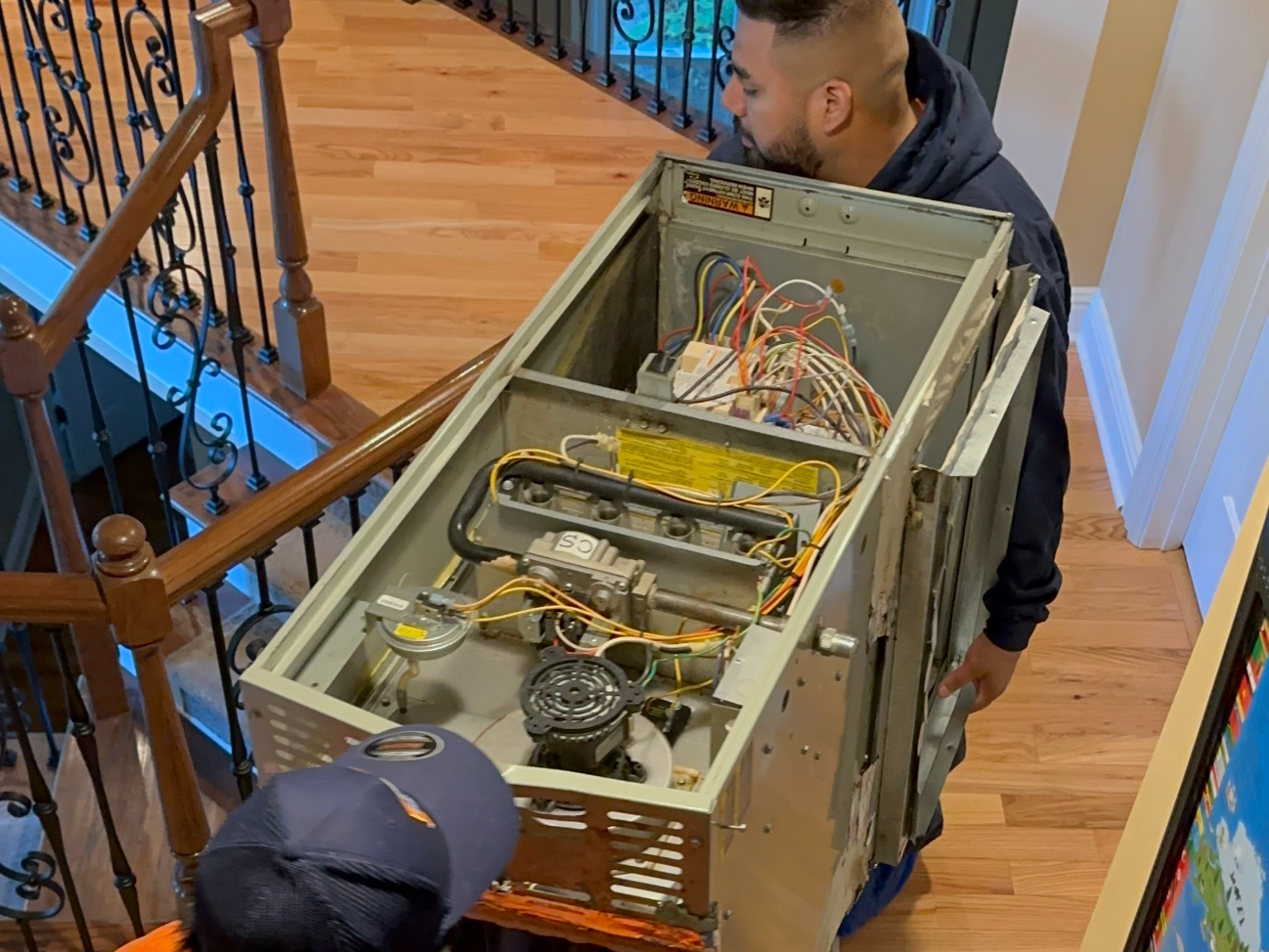 Estes Services Technician Repairing a Furnace