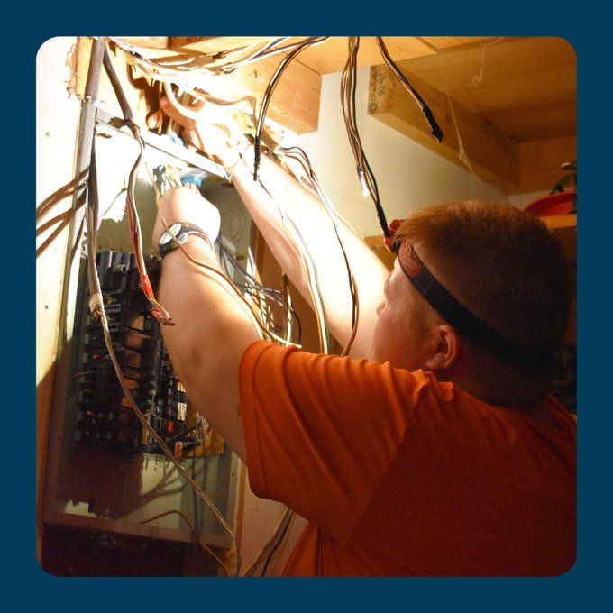 Estes Electrician working on an old electrical panel