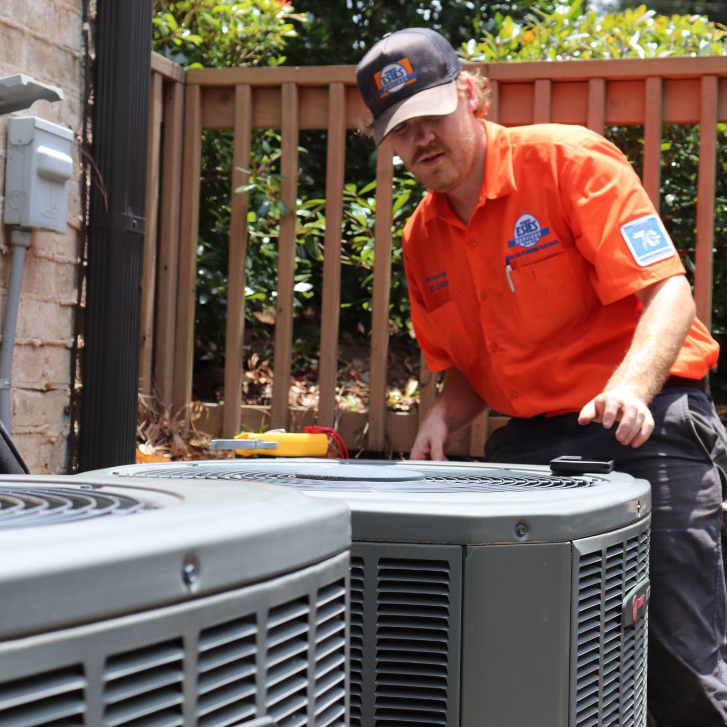 Estes Tech adjusting a blocked condenser unit