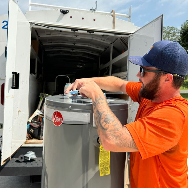 Estes Plumber installing a Tank Rheem Water Heater