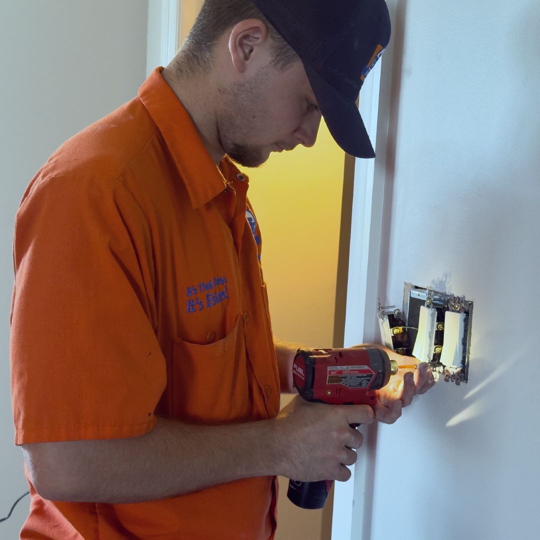 Estes Services Electrician changing an electrical outlet in Atlanta, Georgia