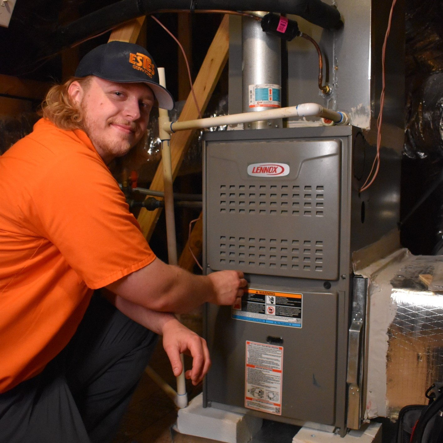 Estes Services HVAC Technician working in a furnace lennox