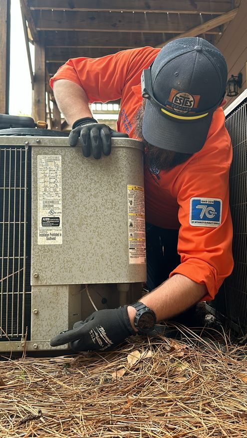 Estes Services Tech repairing an Air Conditioner