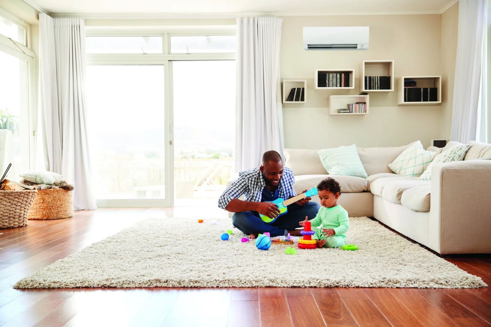 Father and son playing in a living room with an Mini