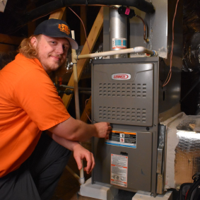 Estes Services HVAC Tech in front of a Estes Van