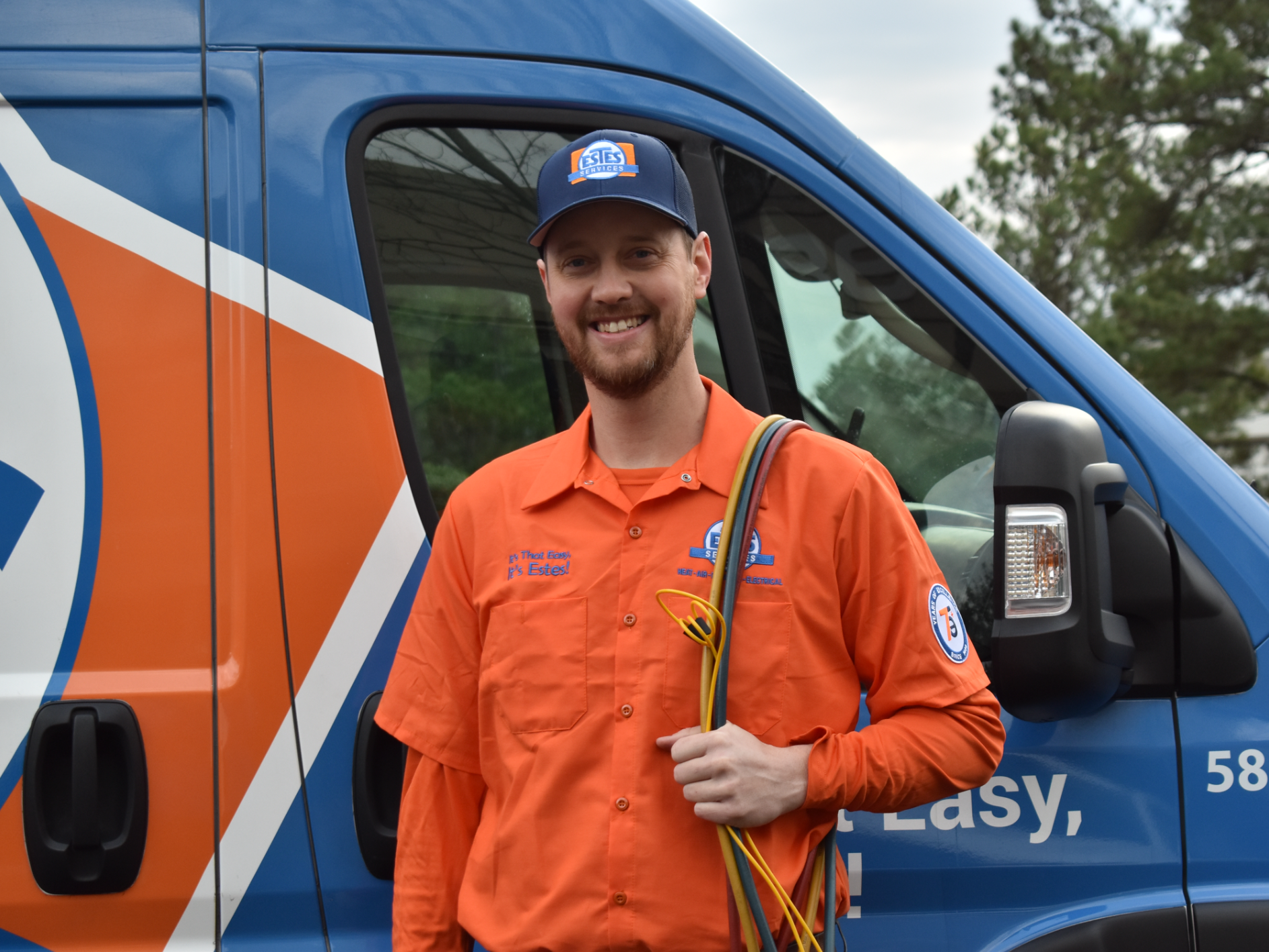 Estes Services Technicians Smiling in front of a truck