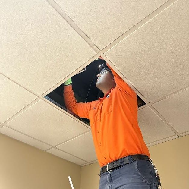 stes Commercial Technician working on HVAC rooftop system