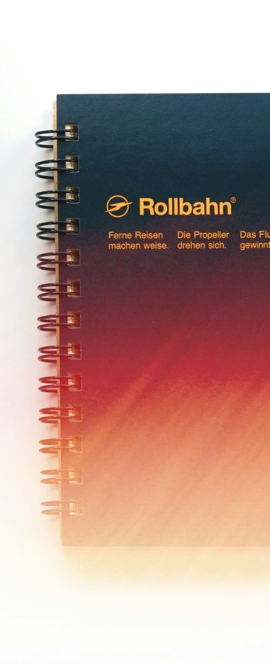 A spiral-bound notebook open showing 360-degree rotation capability