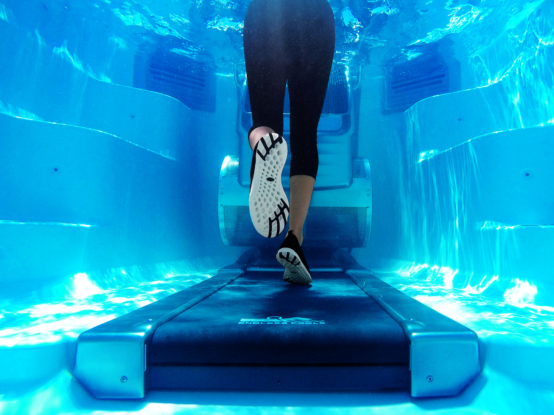 A person running on an underwater treadmill.