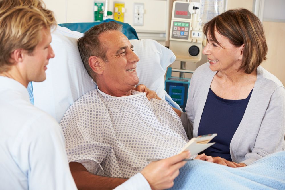 a smiling patient in a hospital bed 